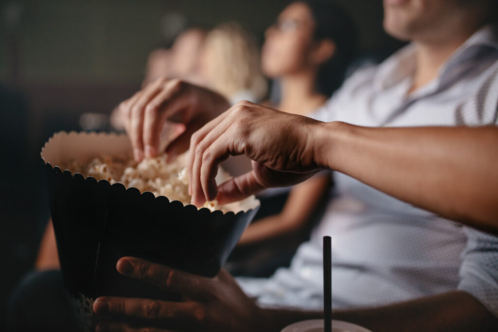 young people eating popcorn in movie theater 2022 02 02 05 06 52 utc