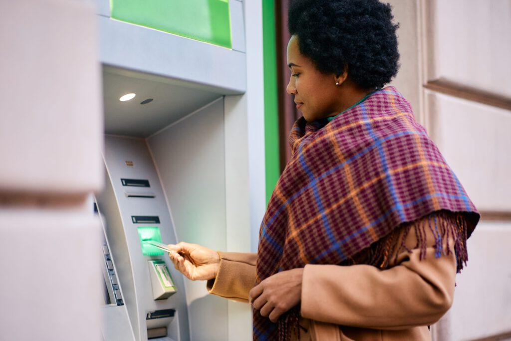 african american woman withdrawing money from atm 2023 11 27 04 51 52 utc min